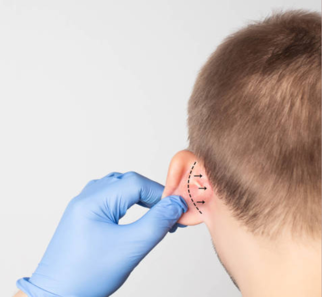 Doctor Branko Glušac holding ear before the surgery
